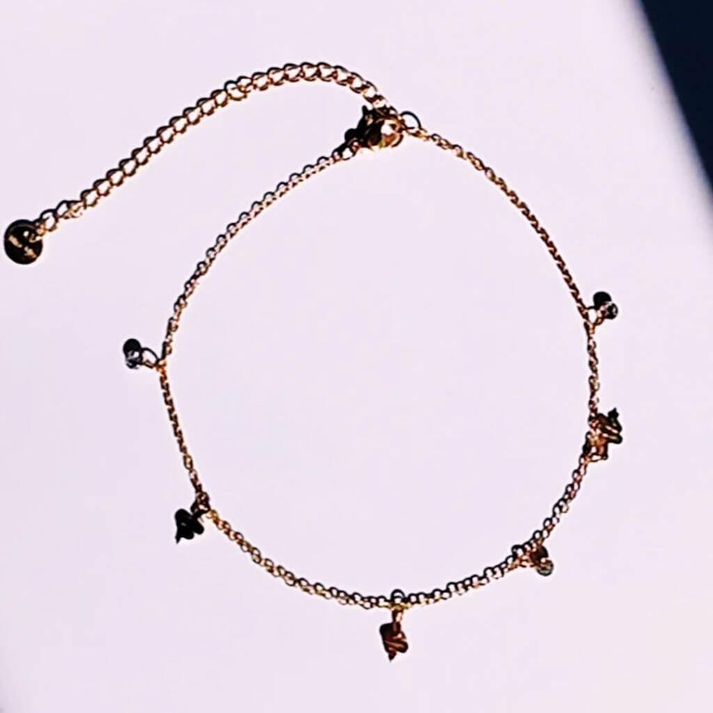 Completa tus outfits veraniegos con la Tobillera Mini snake Acero Baño Oro. Esta delicada tobillera waterproof de cadena fina, de acero con minis colgantes en forma de serpiente y brillantes, es perfecta para llevarla siempre contigo.