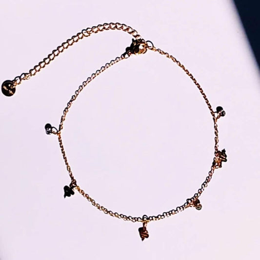 Completa tus outfits veraniegos con la Tobillera Mini snake Acero Baño Oro. Esta delicada tobillera waterproof de cadena fina, de acero con minis colgantes en forma de serpiente y brillantes, es perfecta para llevarla siempre contigo.