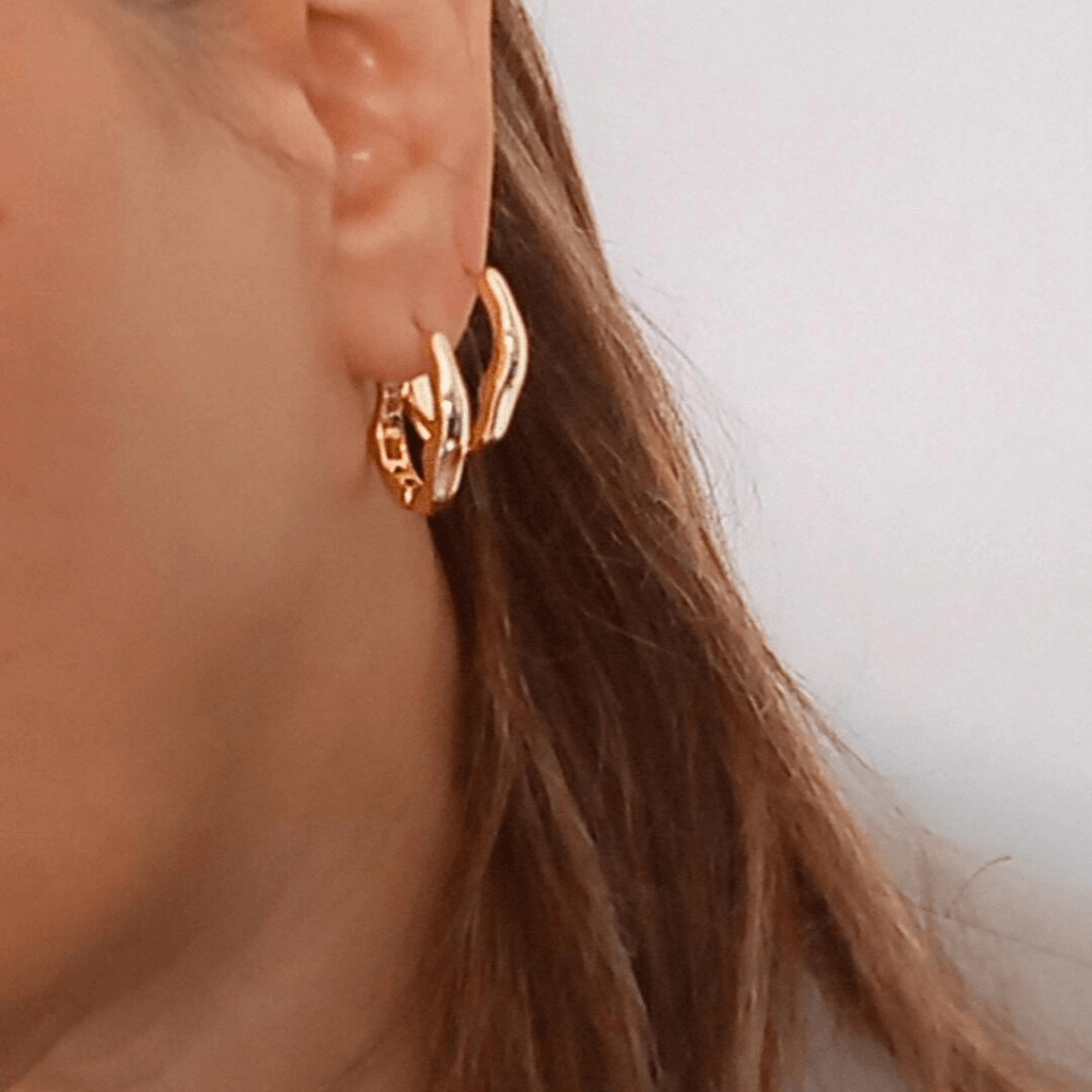 Mujer vistiendo unos Pendientes de aro Irregulares dorados